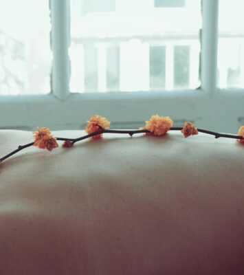 orange petaled flowers on person s back