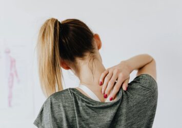 woman touching her back