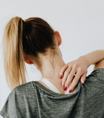 woman touching her back