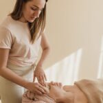 a woman massaging a person s face