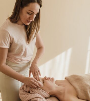 a woman massaging a person s face